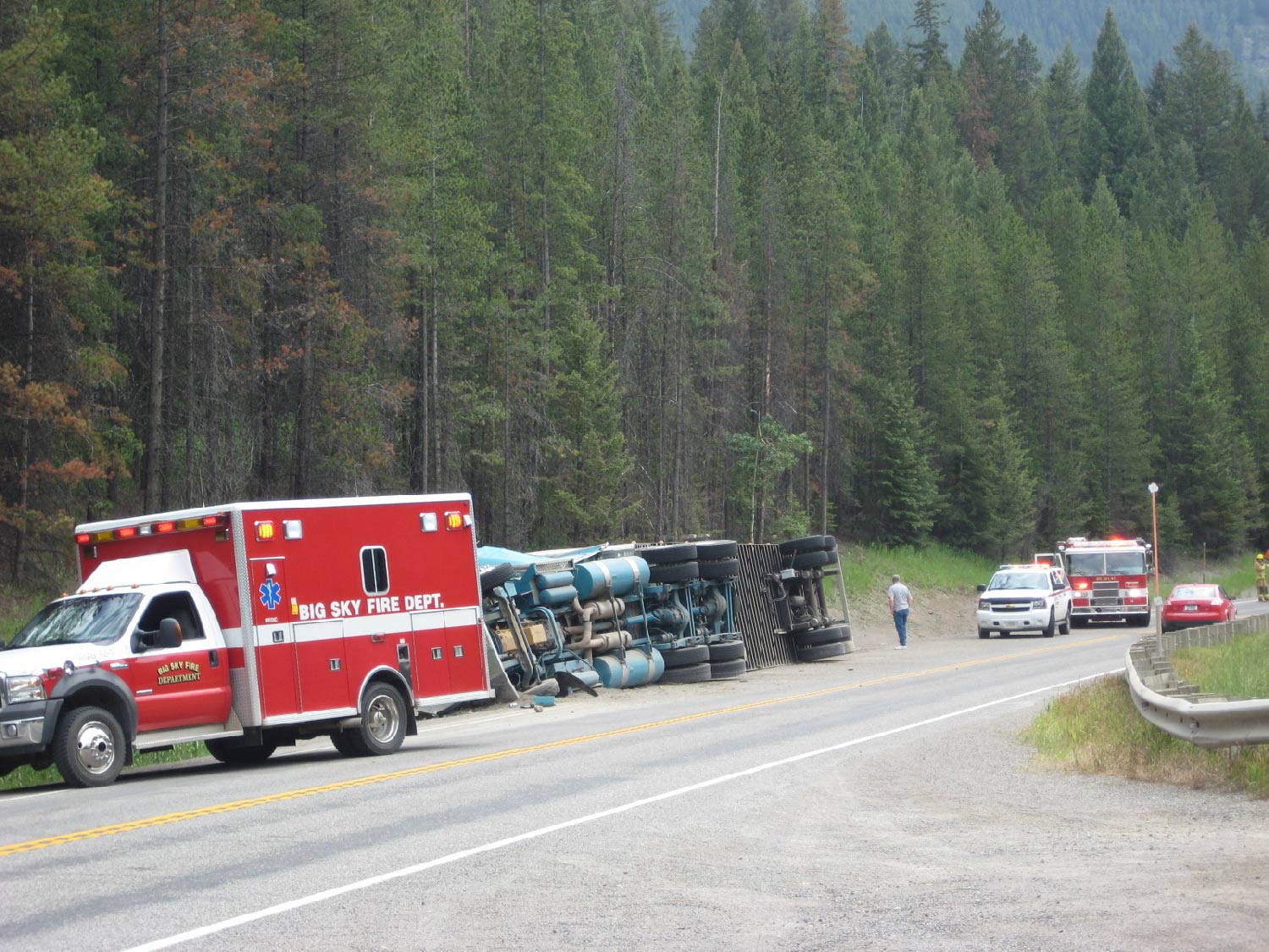 big sky fire department truck at scene of rollover crash on highway