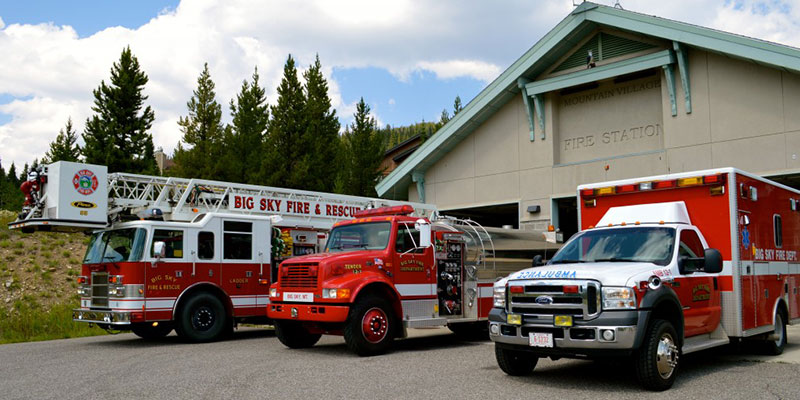 a group of fire trucks parked outside the Big Sky Fire Department