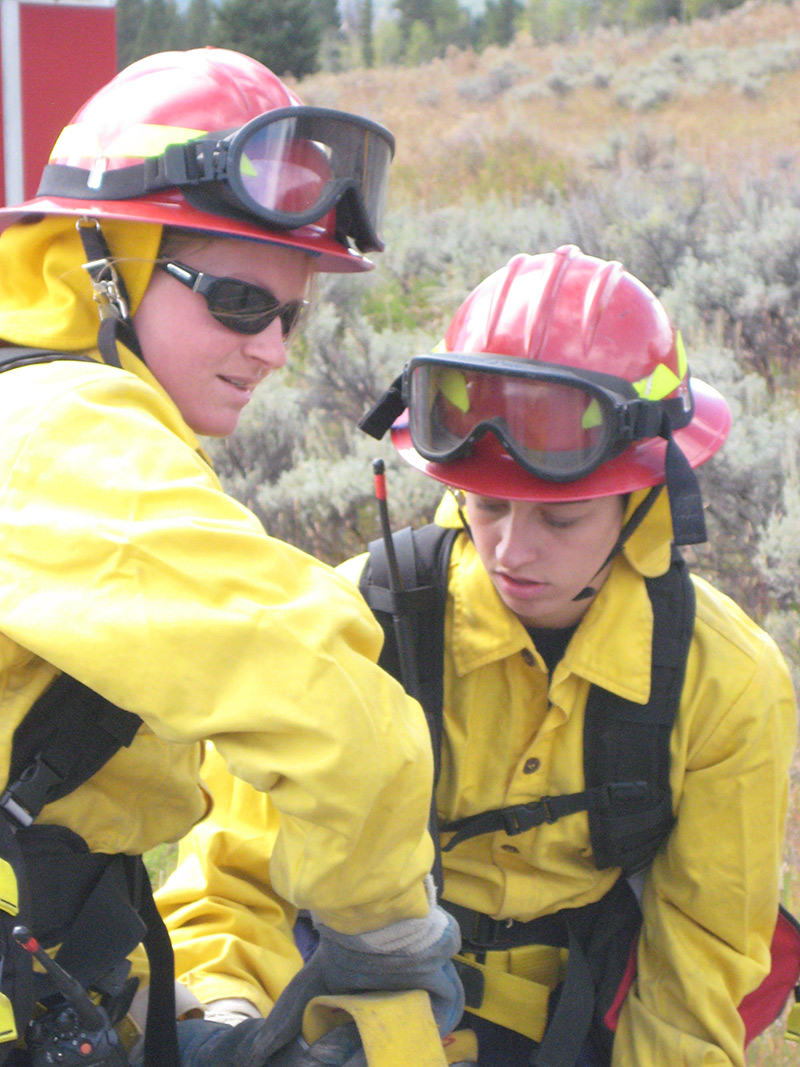 volunteer firefighter with child in gear