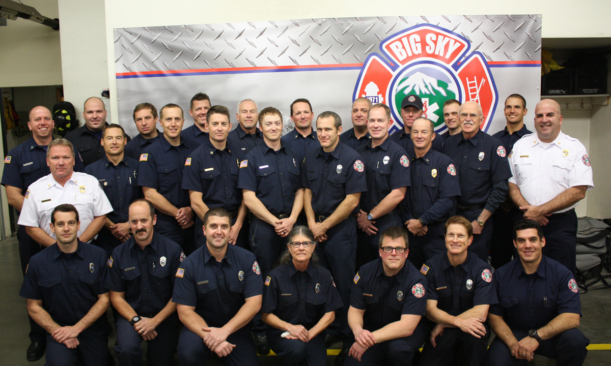 big sky fire department staff posing in front of a truck truck
